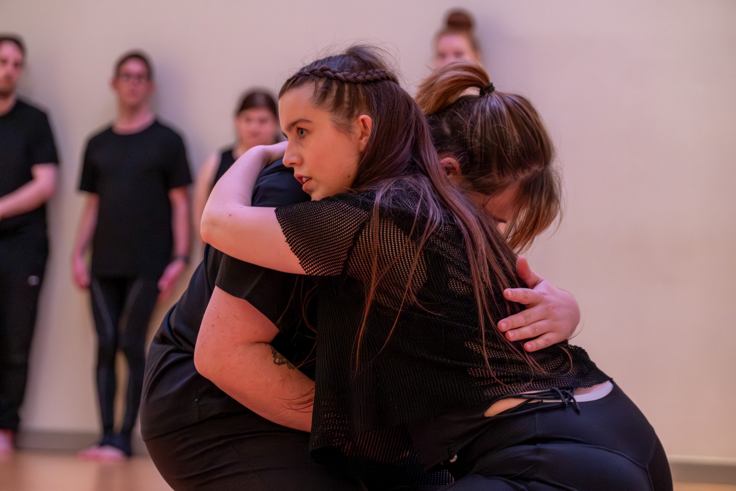 During the rehearsal, two dancers hold each other closely as they learn the choreography.